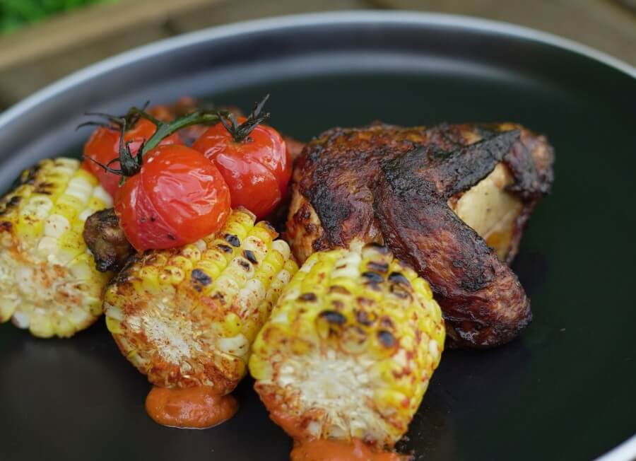Grilled BBQ chicken with tomatoes and corn