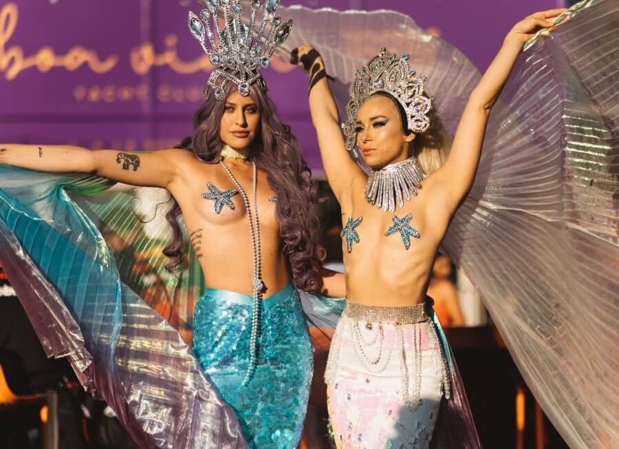 Two mermaids women giving an outdoor show